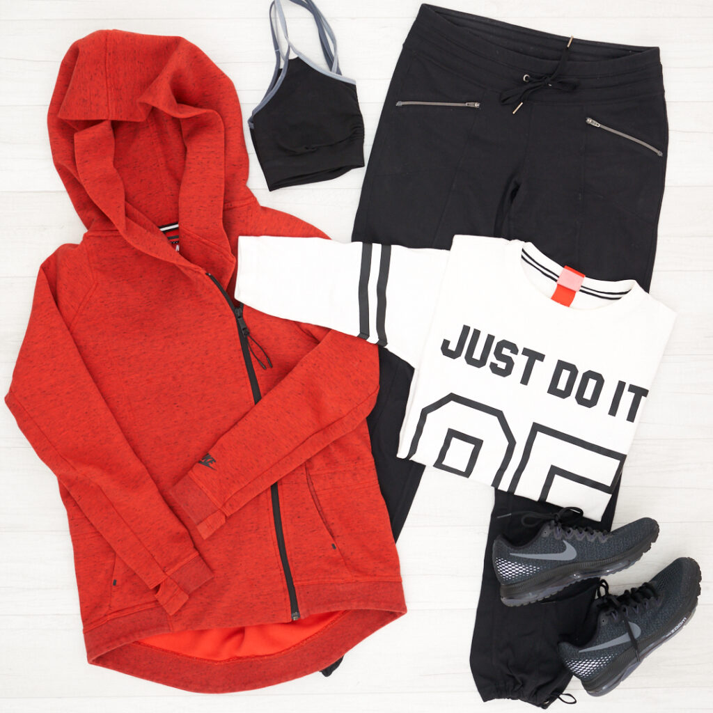 Athleta Metro Slouch pant paired with a Nike zip high/low orange jacket , Nike All Out Running Shoes, and a Just Do It Nike t-shirt.