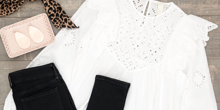 Spring 2018 Trend: White Eyelet Blouse. Flat Lay of White Eyelet Blouse and Black Jeans