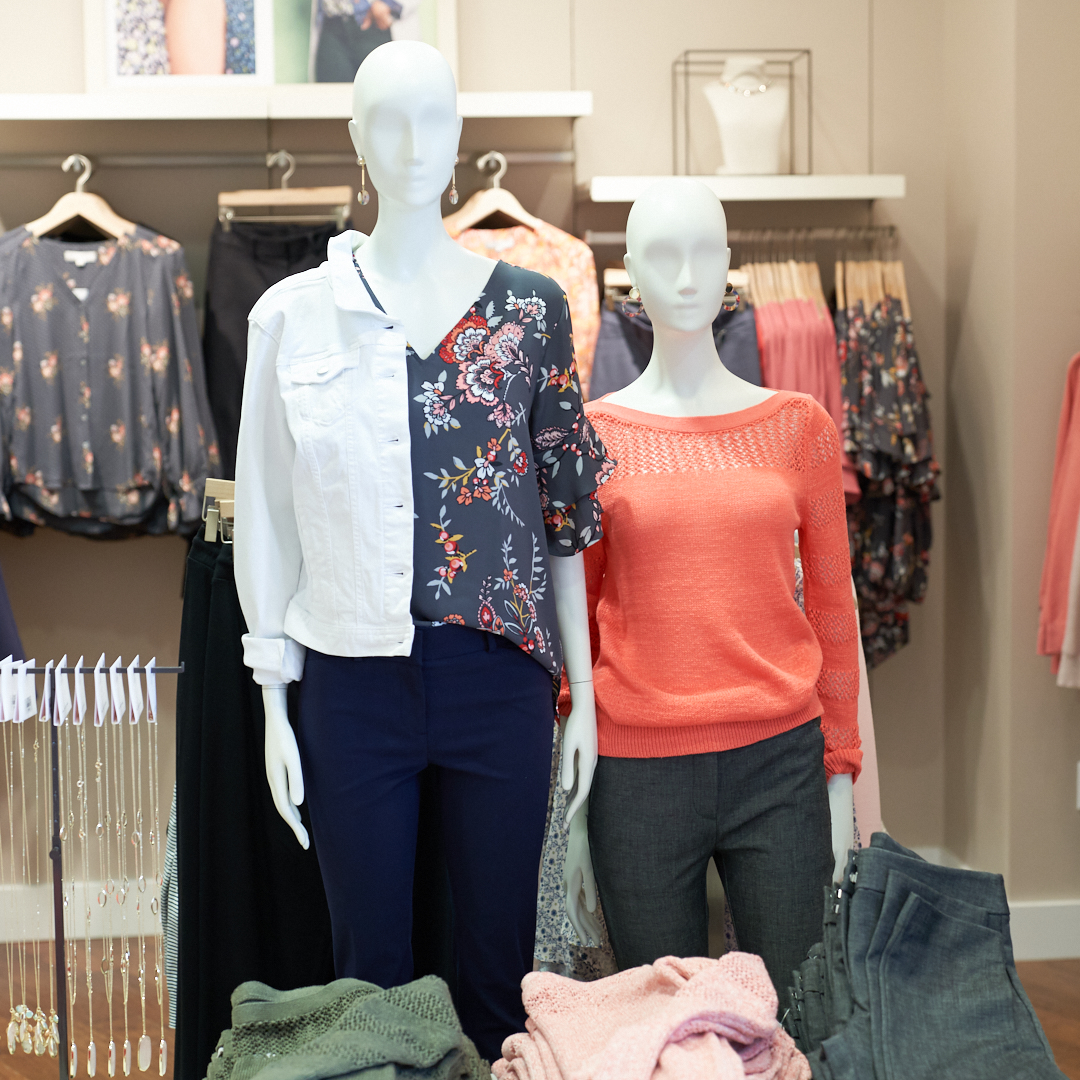 Photo of two mannequins in the front of the store