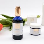 FLat lay of products for Atlantis Skincare - Tulips in the background