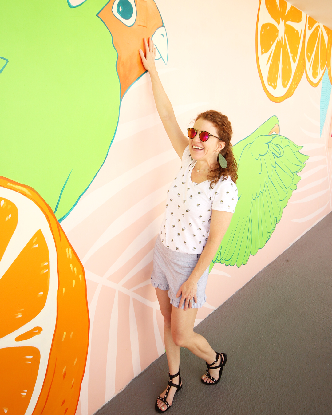 Me standing by a mural wall at the Hotel Adeline