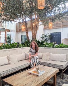 Me sitting on a couch in the lobby of The Scott Resort and Spa wearing my J Crew cottom maxi dress