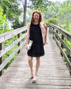 Life styled photo of dress with pink denim jacket, floral pink clutch and pink espadrille wedges