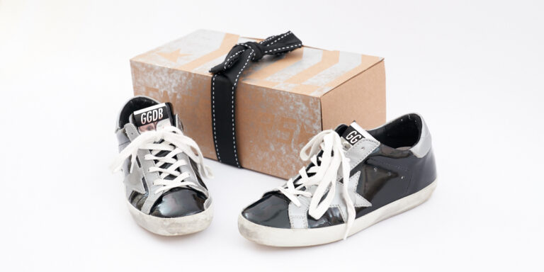 Goldne Goose Sneakers in a Flat lay With the beautiful packaging it came in