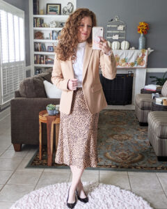 Mirrorshot of me wearing the slip-on midi skirt with a white blouse and camel blazer and pumps for a workwear outfit.